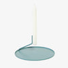Buka Candlestick by Diiis for Souda. aBUKA1001s (turquoise). Simple, elegant, and mysterious, the Buka Candlestick uses two pins to suspend a candle above a metal dish - giving it the appearance that it's levitating. Minimal, yet visually effortless, this candleholder is exactly what you need to create a warm, weightless mood. 