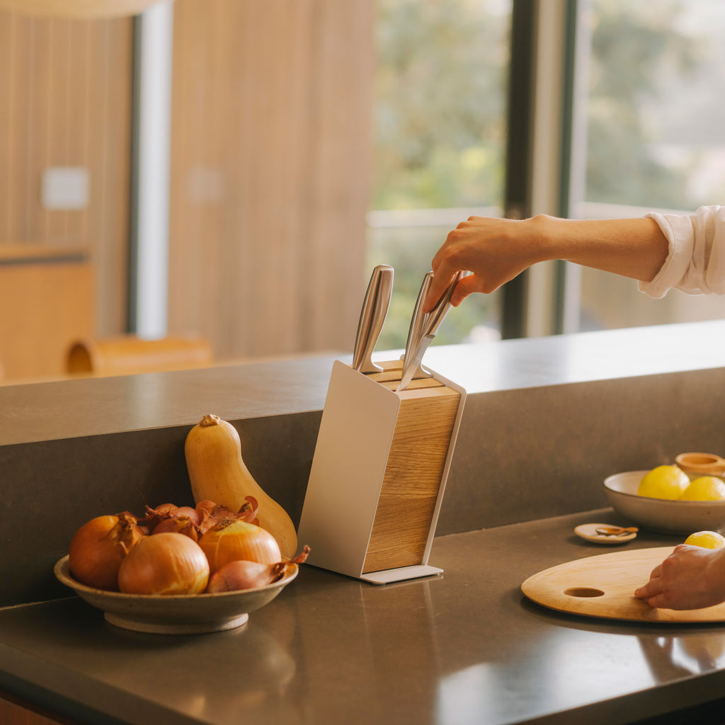 Apto Slot Knife Block - Steel + Wood. It can store up to 6 large knives, or 9+ medium to small knives. The maximum blade length is 8.5 inches (21.5 cm) for the front slot, 8.8 inches (22 cm) for the middle slot, and 9.3 inches (23.5 cm) for the back slot.