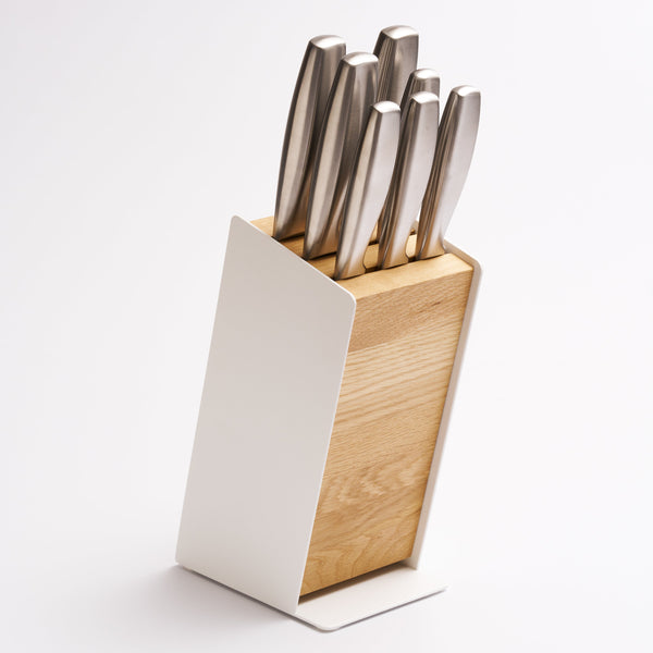 A universal knife block with slots for most knife sizes, removable components for easy cleaning, and a warm wood and steel design for any kitchen.

A home for your knives that keeps them at their best. Open-slot design promotes natural air circulation while removable components make cleaning simple — protecting your blades and preserving your investment for years to come. Universal slots fit most common knife sizes, keeping your collection organized and always within reach.