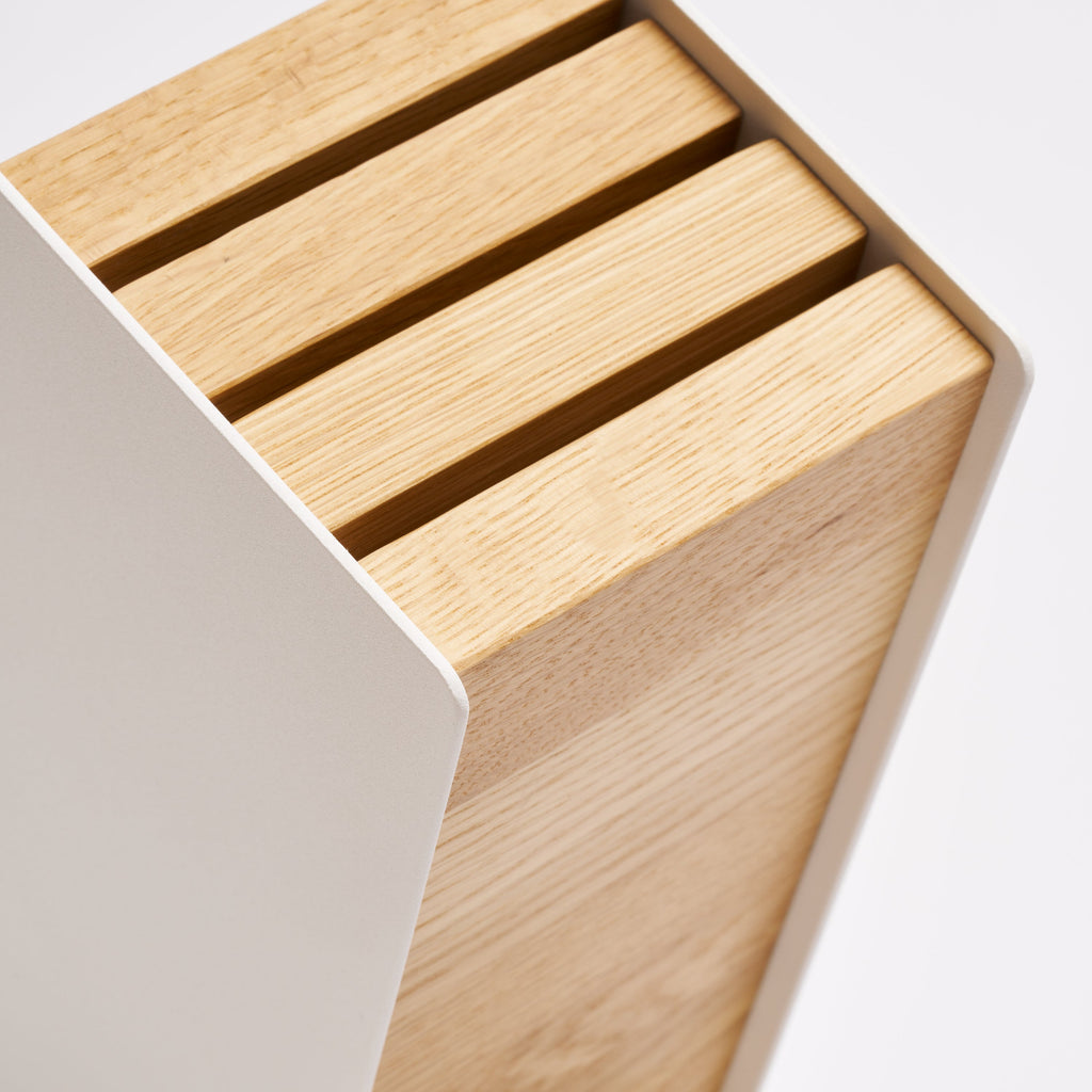 The maximum blade length is 8.5 inches (21.5 cm) for the front slot, 8.8 inches (22 cm) for the middle slot, and 9.3 inches (23.5 cm) for the back slot. It can store up to 6 large knives, or 9+ medium to small knives. The wood pieces are easily removable for cleaning with a soft, damp cloth.