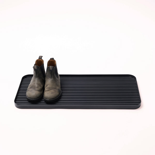 APTO Furrow Boot Tray - Steel - Black. SKU 10490. Stop dirt at the door with this rust-resistant steel tray. Holds up to 3 pairs of shoes and features protective silicone footers. This durable boot tray traps mud, dirt, and debris before it spreads — keeping your floors clean and your home exactly as you left it. A clean home starts at the door.