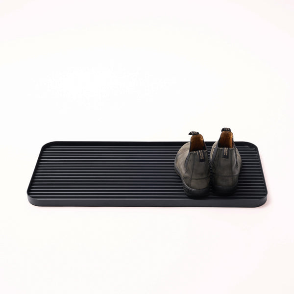 APTO Furrow Boot Tray - Steel - Black. SKU 10490. Stop dirt at the door with this rust-resistant steel tray. Holds up to 3 pairs of shoes and features protective silicone footers. This durable boot tray traps mud, dirt, and debris before it spreads — keeping your floors clean and your home exactly as you left it. A clean home starts at the door.