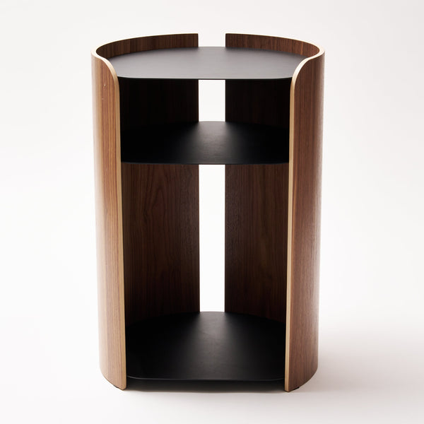 Apto Contour Side Table in walnut plywood and black powder-coated steel. SKU 10801. Bring style and function to any room with this modern three-tier steel and wood side table. Designed with your lifestyle in mind. The table features an opening in the back for easy cable management and charging. Balances modern steel surfaces with stylish molded plywood.
