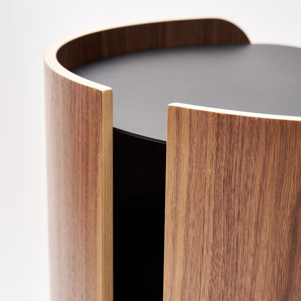 Apto Contour Side Table in walnut plywood and black powder-coated steel. SKU 10801. Bring style and function to any room with this modern three-tier steel and wood side table. Designed with your lifestyle in mind. The table features an opening in the back for easy cable management and charging. Balances modern steel surfaces with stylish molded plywood.