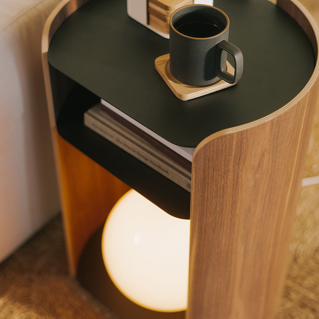 APTO Side Table - Steel + Wood - Black. SKU 10801. Bring style and function to any room with this modern three-tier steel and wood side table. Designed with your lifestyle in mind. The table features an opening in the back for easy cable management and charging. Balances modern steel surfaces with stylish molded plywood.