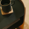 APTO Side Table - Steel + Wood - Black. SKU 10801. Bring style and function to any room with this modern three-tier steel and wood side table. Designed with your lifestyle in mind. The table features an opening in the back for easy cable management and charging. Balances modern steel surfaces with stylish molded plywood.