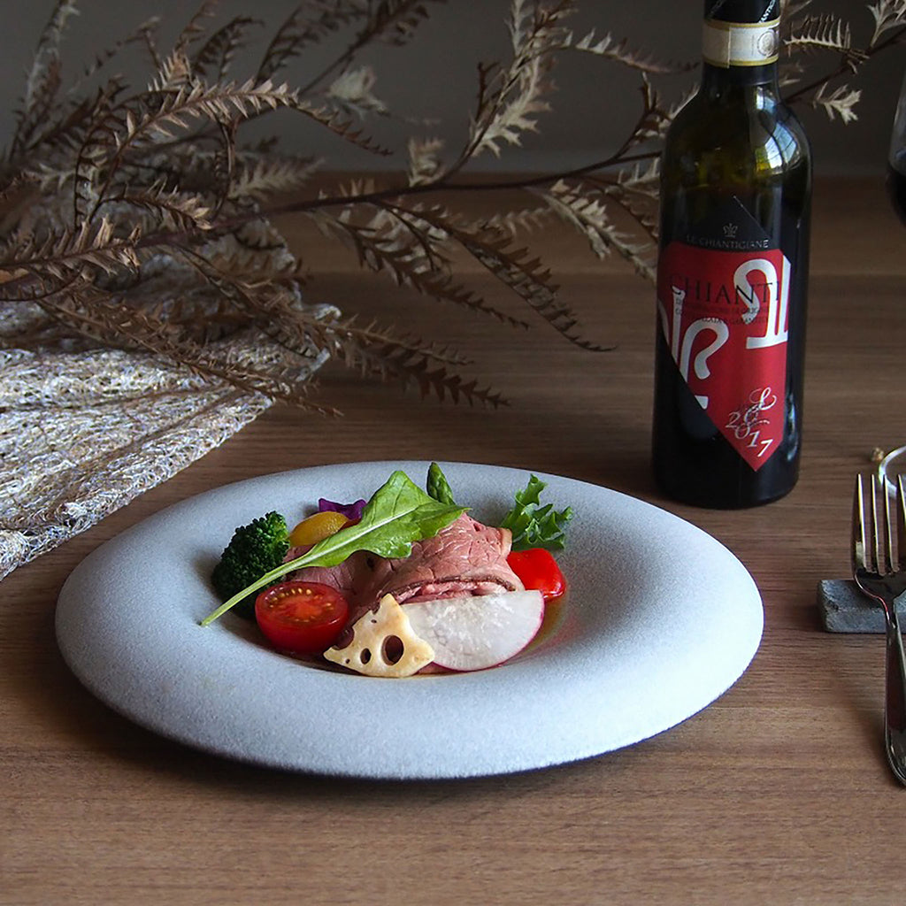 Confit Plate features beautiful curves and a smooth texture. It envelops and highlights your food. Simply place food in the center for an elegant presentation. The deep recesses make it suitable for serving dishes with lots of liquid. Confit 26cm / 10.2" plate dimensions: 26.5cm diameter x 3.3cm / 10.4" diameter x 1.3”; SKU 154-0041.