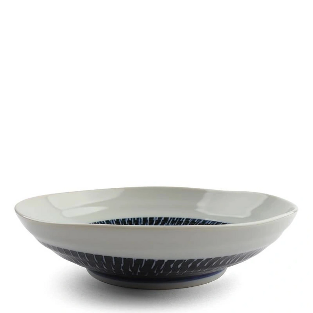 Tobikanna Blue Shallow Bowl 6.75" diameter. Tobikanna Indigo Blue Series shallow bowl.  Great for salads and snacks. 6.75" diameter x 2"h. Ceramic. Microwave/dishwasher safe. Made in Japan. SKU 170-608B. UPC 845332034404.