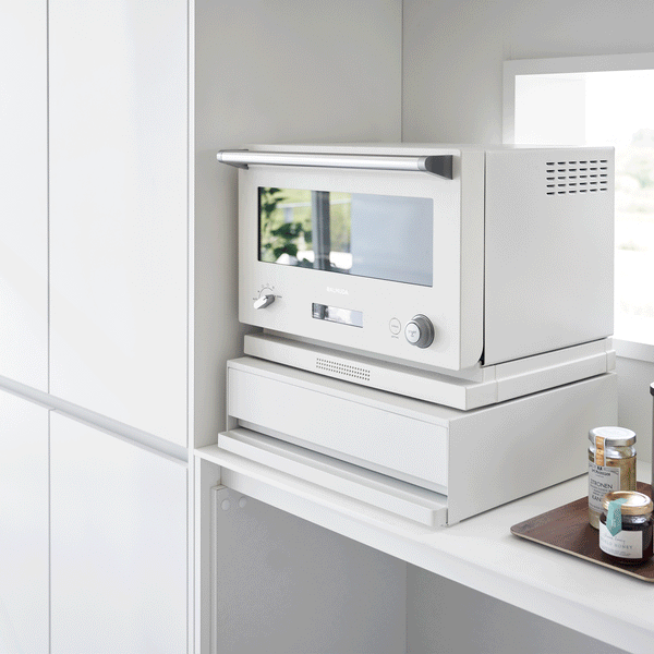 A kitchen drawer, pull-out shelf, and appliance stand in one, this organizer creates space and convenience in the kitchen.
