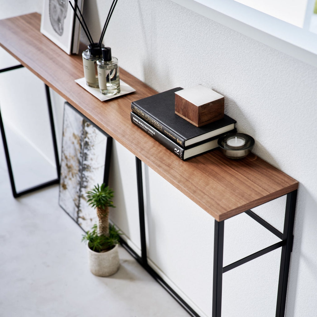 With a natural woodgrain top and minimalistic steel legs, this sleek design magically makes everything placed upon it look intentionally styled.