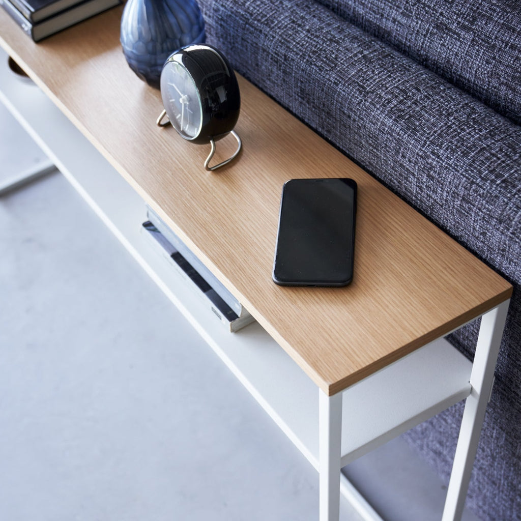 With a natural woodgrain top and minimalistic steel legs, this sleek design magically makes everything placed upon it look intentionally styled.