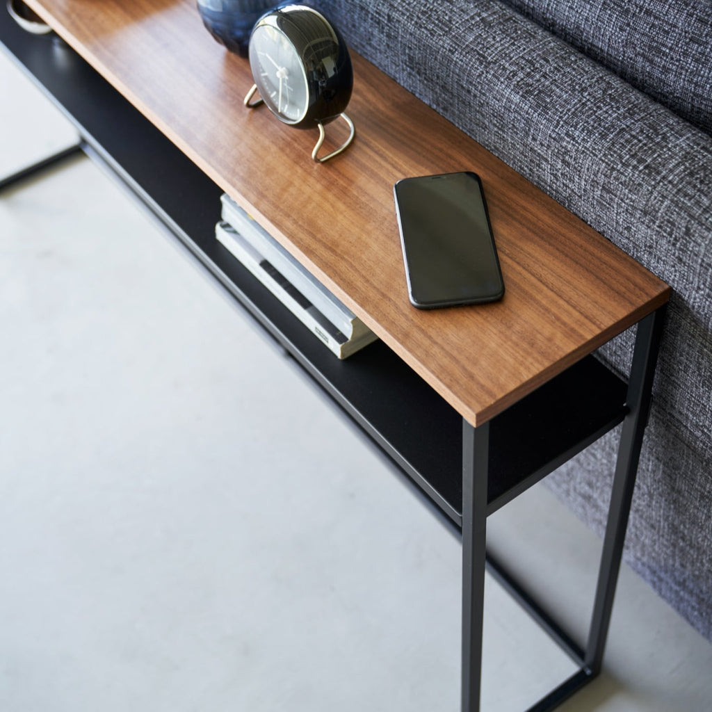 With a natural woodgrain top and minimalistic steel legs, this sleek design magically makes everything placed upon it look intentionally styled.