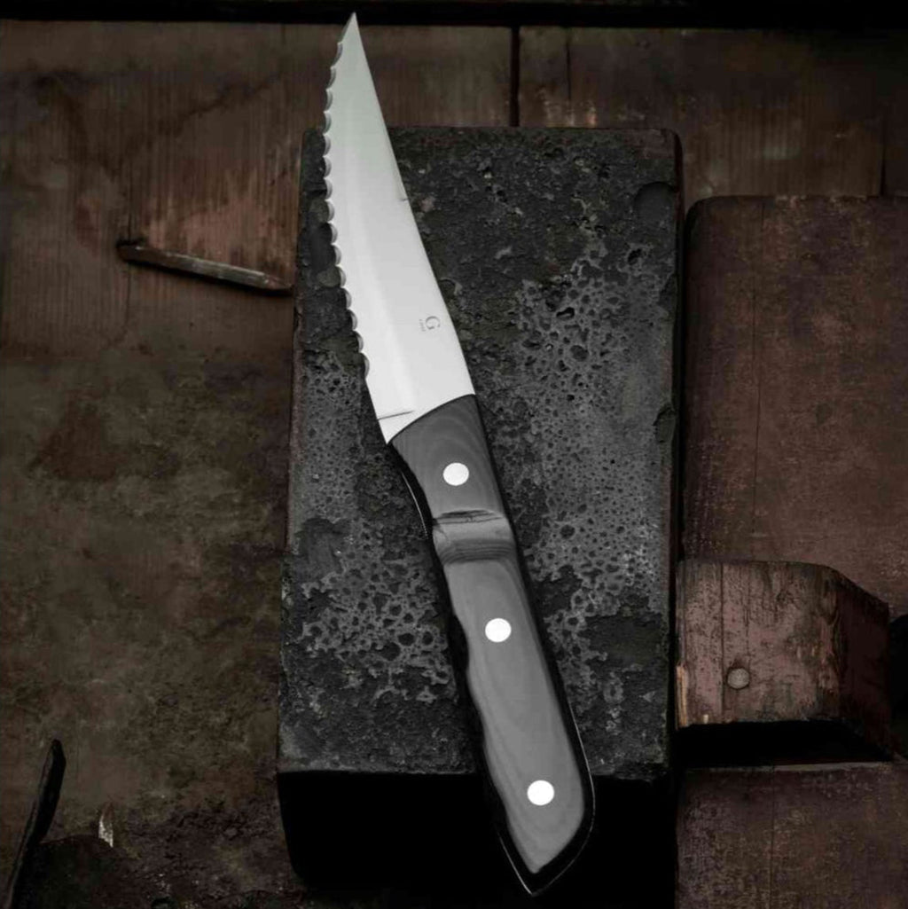 Old Farmer Micarta Black Steak knife XL. SKU 20349. Old Farmer is a beautiful and rustic stainless steel steak cutlery. Old Farmer Black has a high-quality POM plastic handle, while Old Farmer Classic features a pressed rosewood handle. The cutlery is designed by Bent Severin, an industrial designer who worked with perfection in every material. He was considered one of Denmark’s leading sculptors and designers with significant influence in the creative world.