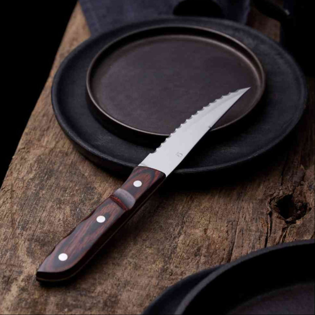 Old Farmer Classic Steak knife XL. SKU 20351. Old Farmer is a beautiful and rustic stainless steel steak cutlery. Old Farmer Black has a high-quality POM plastic handle, while Old Farmer Classic features a pressed rosewood handle. The cutlery is designed by Bent Severin, an industrial designer who worked with perfection in every material. He was considered one of Denmark’s leading sculptors and designers with significant influence in the creative world.