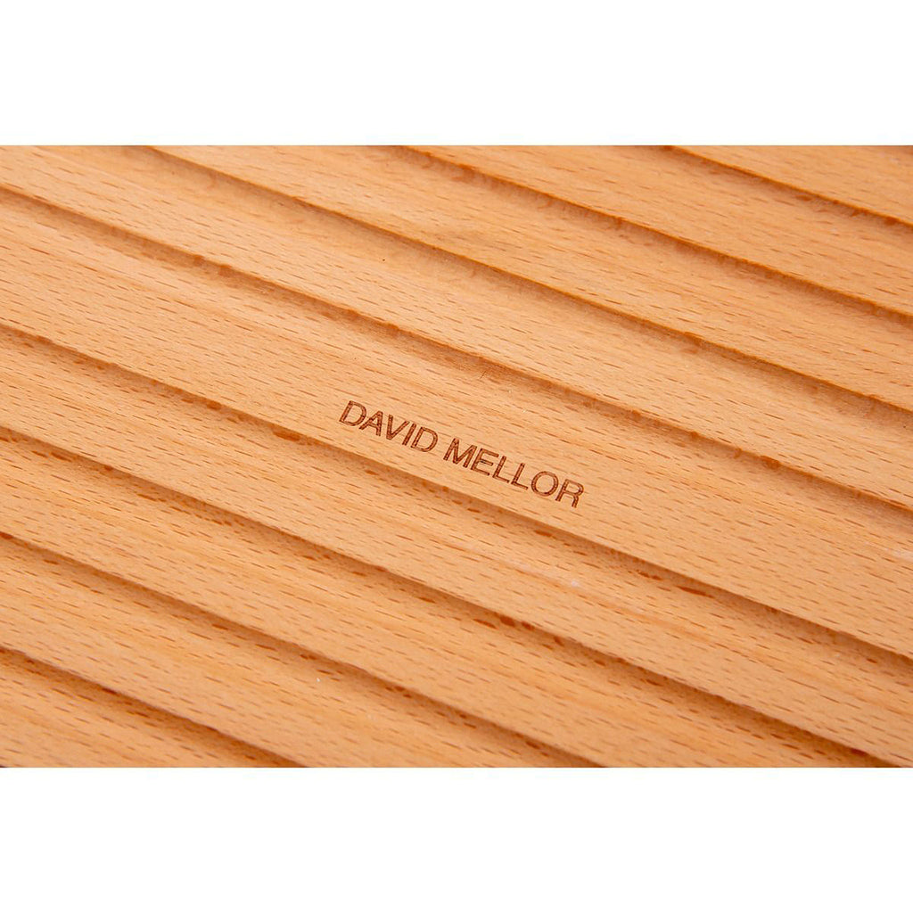 Grooved breadboard 44cm. SKU 2450310. Sculptural design with milled grooves to contain crumbs. European beech with non-slip feet. Our own-brand cutting boards are handmade in wood from sustainable sources by small specialist craft workshops. These are really top quality products.