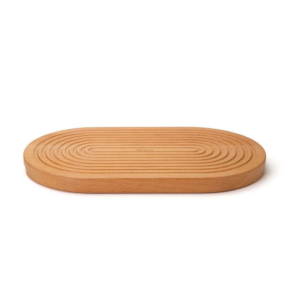 Grooved breadboard 44cm. SKU 2450310. Sculptural design with milled grooves to contain crumbs. European beech with non-slip feet. Our own-brand cutting boards are handmade in wood from sustainable sources by small specialist craft workshops. These are really top quality products.
