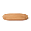 Grooved breadboard 44cm. SKU 2450310. Sculptural design with milled grooves to contain crumbs. European beech with non-slip feet. Our own-brand cutting boards are handmade in wood from sustainable sources by small specialist craft workshops. These are really top quality products.