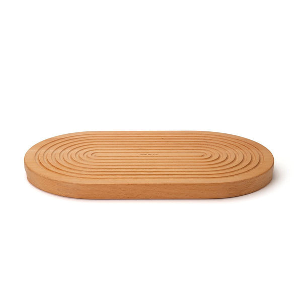 Grooved breadboard 44cm. SKU 2450310. Sculptural design with milled grooves to contain crumbs. European beech with non-slip feet. Our own-brand cutting boards are handmade in wood from sustainable sources by small specialist craft workshops. These are really top quality products.