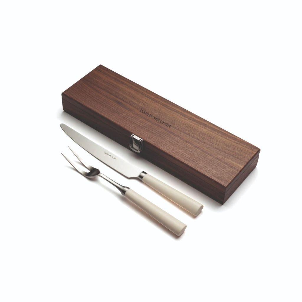 New edition of David Mellor’s famous ‘Pride’ carving set first designed in 1956. Expertly hand finished with ivory coloured handles. Super-sharp high carbon stainless steel blade has been ice-hardened to minus 80ºc.

Comes in a solid walnut case with hinged lid and clasp. Comprising:

Carving Knife 20cm
Carving Fork 25.5cm
Box 35.5 x 11 x 5cm deep