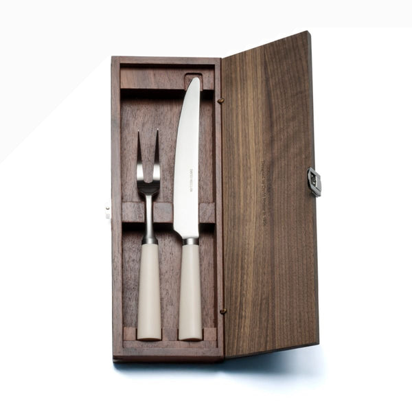 David Mellor Design Pride carving set in walnut box. SKU 2518325.New edition of David Mellor’s famous ‘Pride’ carving set first designed in 1956. Expertly hand finished with ivory coloured handles. Super-sharp high carbon stainless steel blade has been ice-hardened to minus 80ºc. Comes in a solid walnut case with hinged lid and clasp.