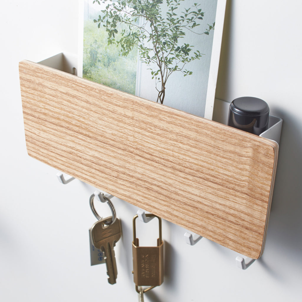Best of all, the rack is just 7 inches wide and has five hooks and room for a few letters.