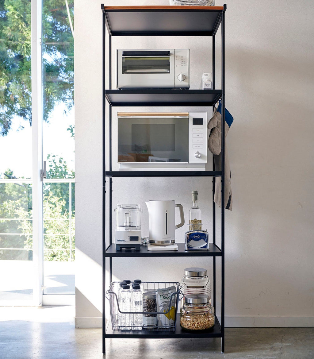 This kitchen appliance storage rack creates a dedicated space in the kitchen for your mid-sized appliances such as toaster ovens, microwaves, and blenders. The bottom compartment accommodates small refrigerators and garbage cans.