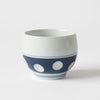 A set of a round earthenware teapot and a teacup, which are carefully hand-carved and have good drainage for tea. While mass-produced polka dot tableware is made by pasting stickers, Soesen Seitosho draws each circle by hand using a technique called “scraping”. The indigo part of the bottom of the tableware is made uniform in size, depth, and the feeling of the circles. 