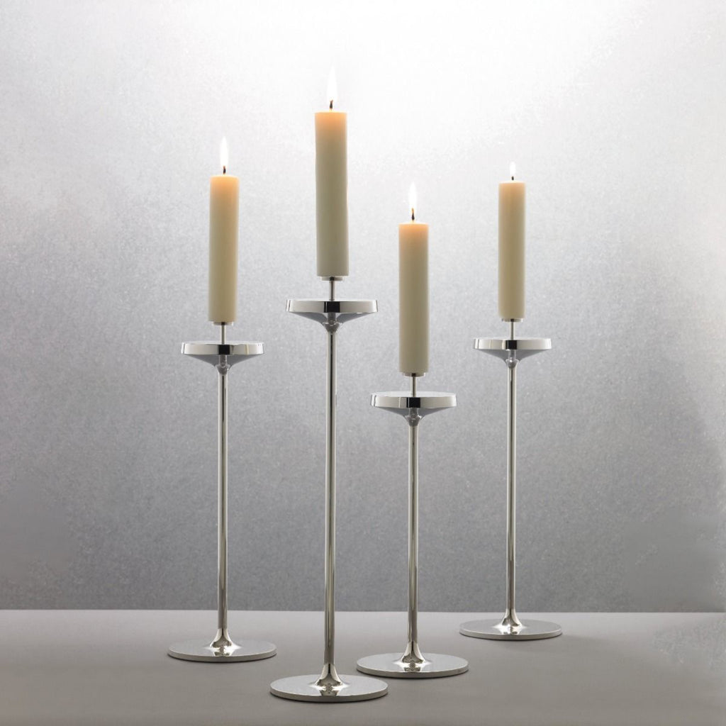 David Mellor Embassy stainless steel candlesticks. Originally designed in 1963 for use in British embassies abroad and previously only available in silver plate, we are pleased to now introduce a stainless steel version of this design classic. These spectacular candlesticks add real height and elegance to a table setting. Use individually or group together different heights.