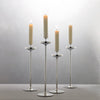 David Mellor Embassy stainless steel candlesticks. Originally designed in 1963 for use in British embassies abroad and previously only available in silver plate, we are pleased to now introduce a stainless steel version of this design classic. These spectacular candlesticks add real height and elegance to a table setting. Use individually or group together different heights.