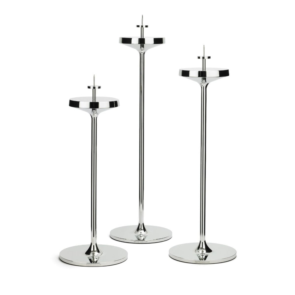 David Mellor Embassy stainless steel candlesticks. Originally designed in 1963 for use in British embassies abroad and previously only available in silver plate, we are pleased to now introduce a stainless steel version of this design classic. These spectacular candlesticks add real height and elegance to a table setting. Use individually or group together different heights.