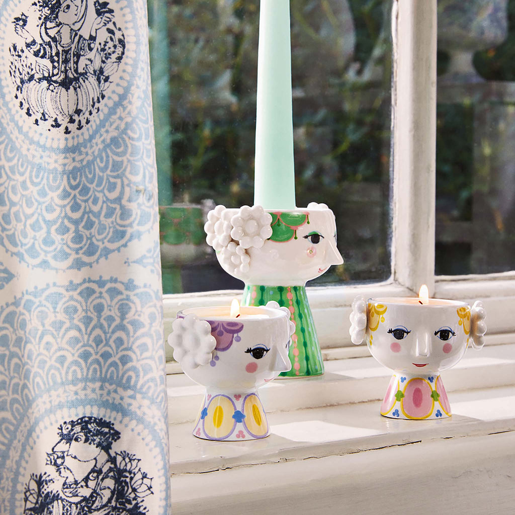 With her bright smile, blushing cheeks, and colorful embellishments, Eva embodies the essence of Bjørn Wiinblad. 