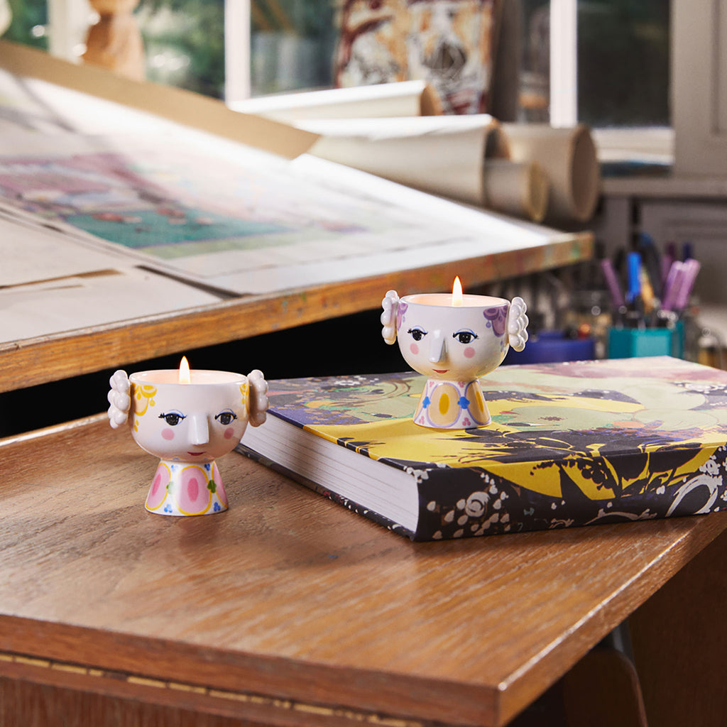 These tealight holders are 2.4 inches tall and have a diameter of 2.6 inches. Each set includes two tealight holders: one with yellow and one with lavender 'hair', both adorned with delightfully vibrant painted dresses. 
