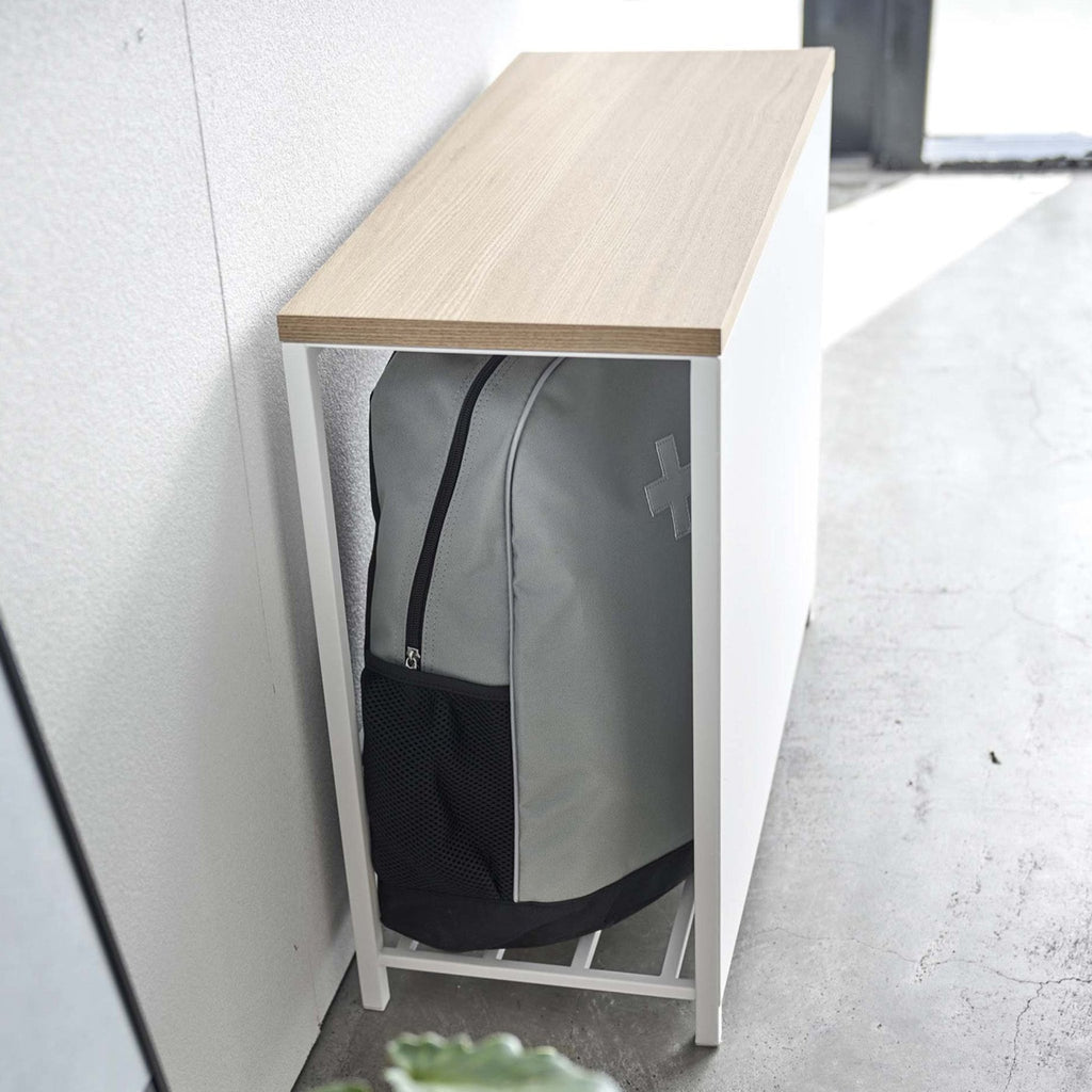 Part of the sleekness of this solution is a stylish front panel that hides the contents, while still allowing easy access from the side. A great way to prevent cluttering without bringing in larger furniture that might take up too much space.