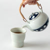 SKU 62496 Soesen Mizutama Maru Dobin (Round with Arched Handle) Teapot. Mizutama teaware is now a staple and symbol for the Japanese dining table. Soesen Kiln craftsmen continue the traditional technique of hand making every part of the tea ware and hand-carving each piece to create the indented polka-dot design. 