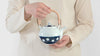 SKU 62496 Soesen Mizutama Maru Dobin (Round with Arched Handle) Teapot. Mizutama means "polka dots" in Japanese. Synonymous with Hizen Yoshida ware, this pattern is attributed to white stones at the bottom of the Narutani River in the upper stream of Haguchi River running through Yoshida village. Mizutama teaware is now a staple and symbol for the Japanese dining table. 