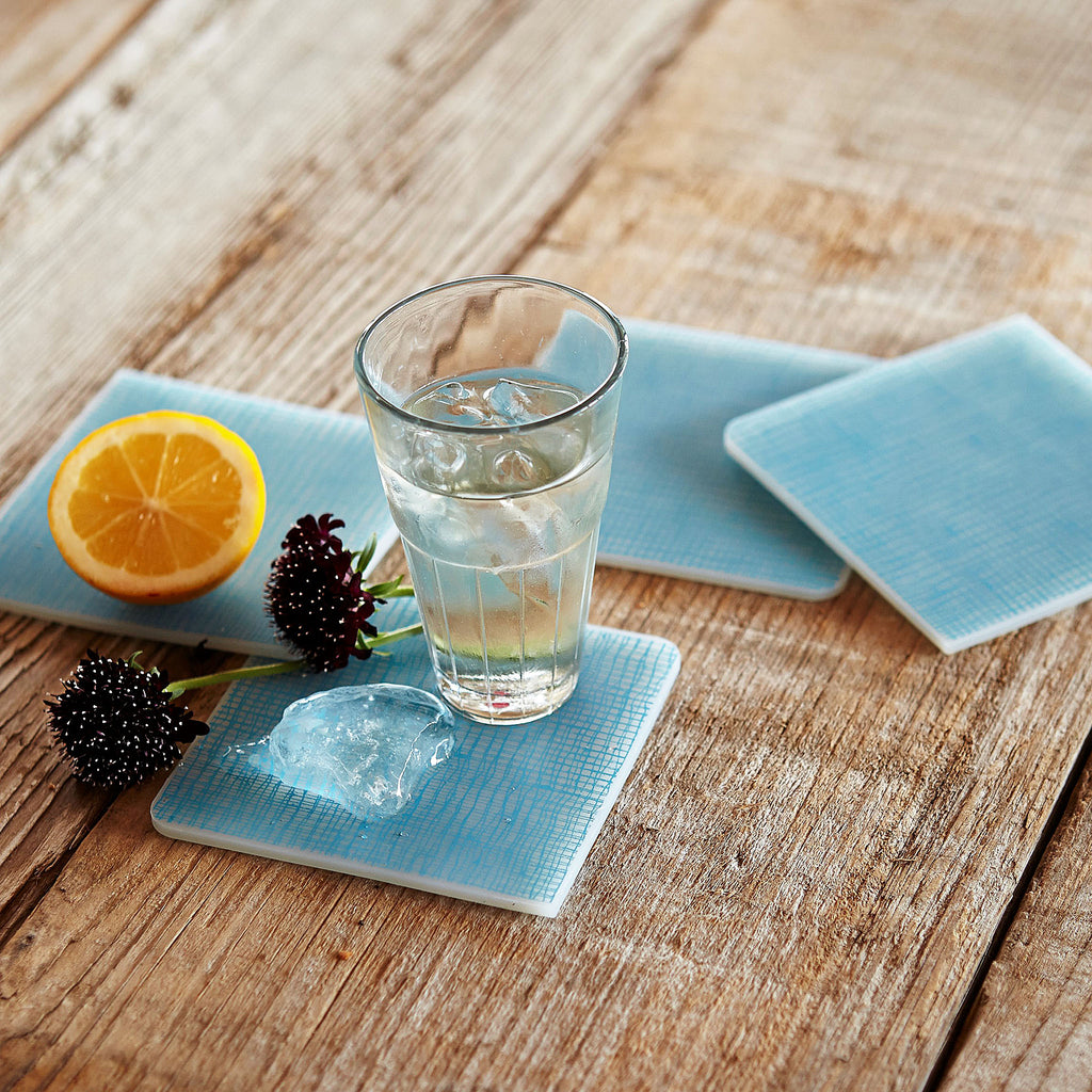 Modern-Twist Silicone Coasters : Linen - Seafoam Set of 4. This forgiving coaster protects your surfaces from heat & water damage with silky soft silicone that never wears or tears. 