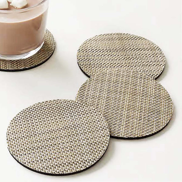 A plush, protective layer of Chilewich BioFelt® backing cushions these durable yet refined coasters. Elegantly banded in sets of four, they are ready for gifting. Made from recycled fibers, the cushioned base layer protects the underlying surface from moisture. Each coaster set includes four coasters in a single color. Suitable for indoor and outdoor use. Made in the USA. Free of phthalates.