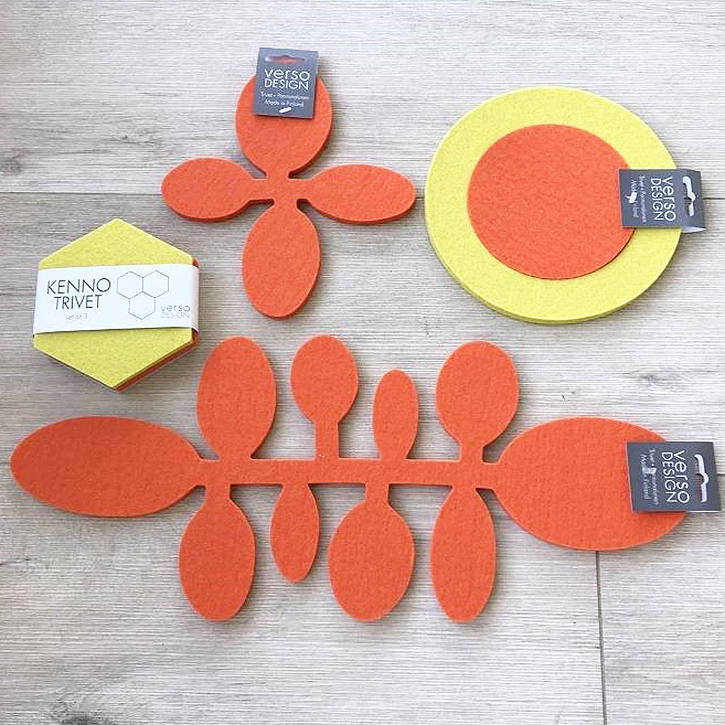 Verso Design Papu (Bean) wool-felt trivets in orange. These trivets and table runners are from Verso Design, a Finnish design house that specializes in modern textiles and innovative home accessories inspired by nature. The design features beans on a vine, laser-cut from thick, felted wool.