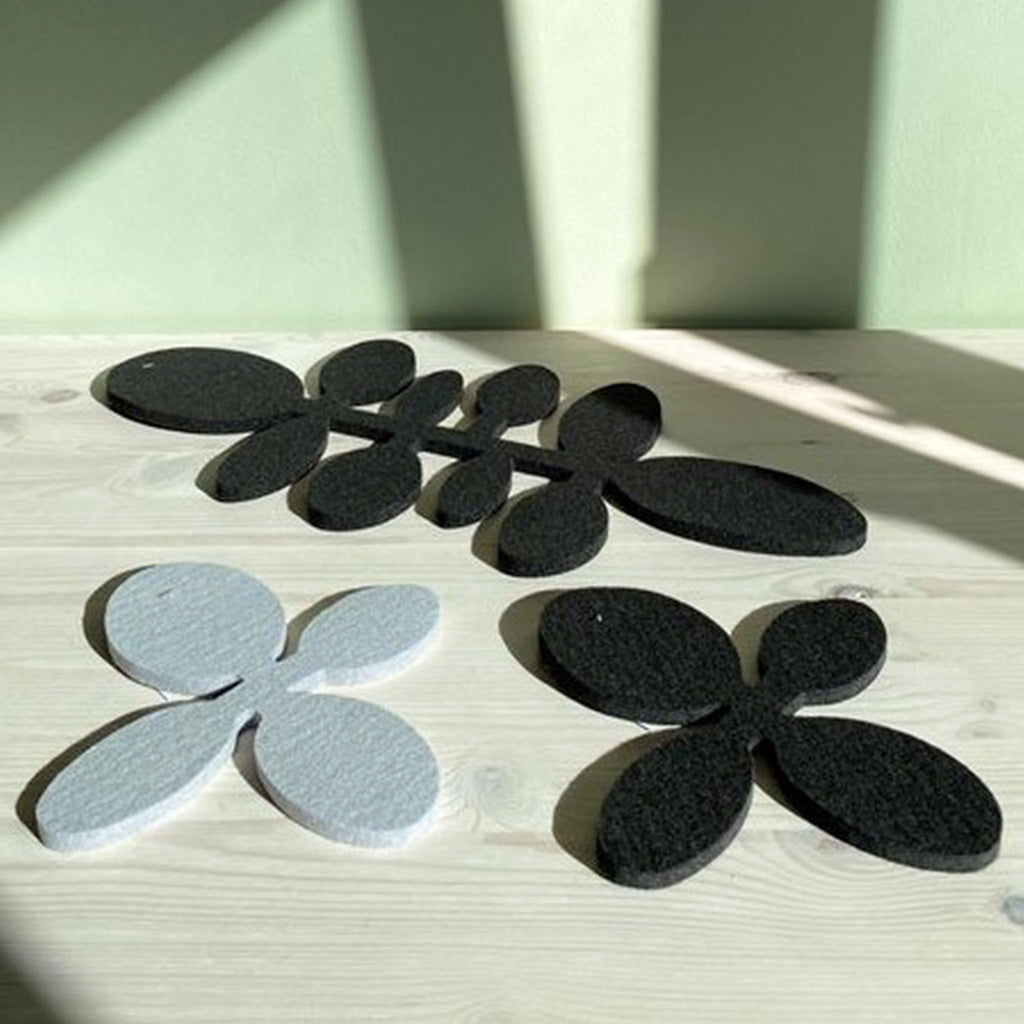 These trivets and table runners are from Verso Design, a Finnish design house that specializes in modern textiles and innovative home accessories inspired by nature. The design features beans on a vine, laser-cut from thick, felted wool.
