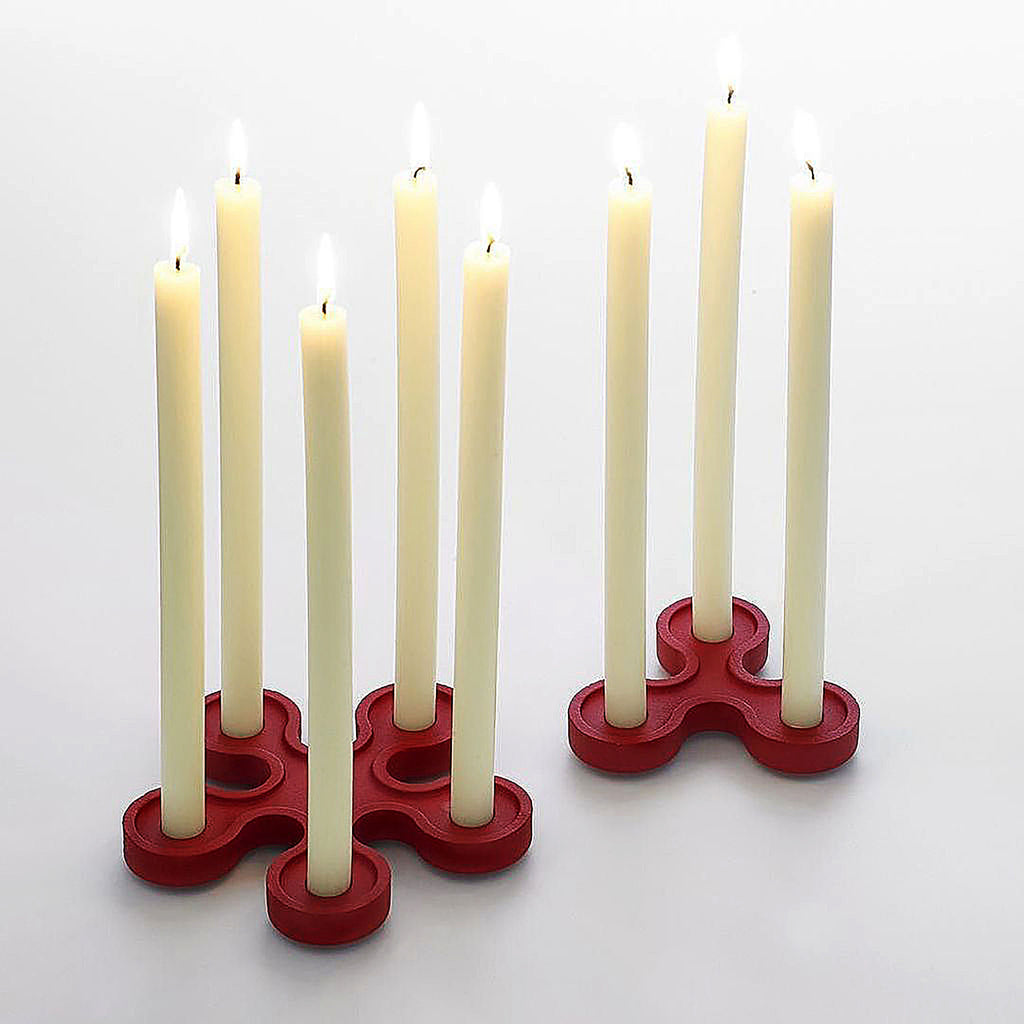 Designed to be used singly or assembled in different permutations to form a spectacular table setting.

Made in matt black with 3 holders. Underside of each candleholder is stamped 1972, the year of its design. Also available in bright red or as a 5-light version.