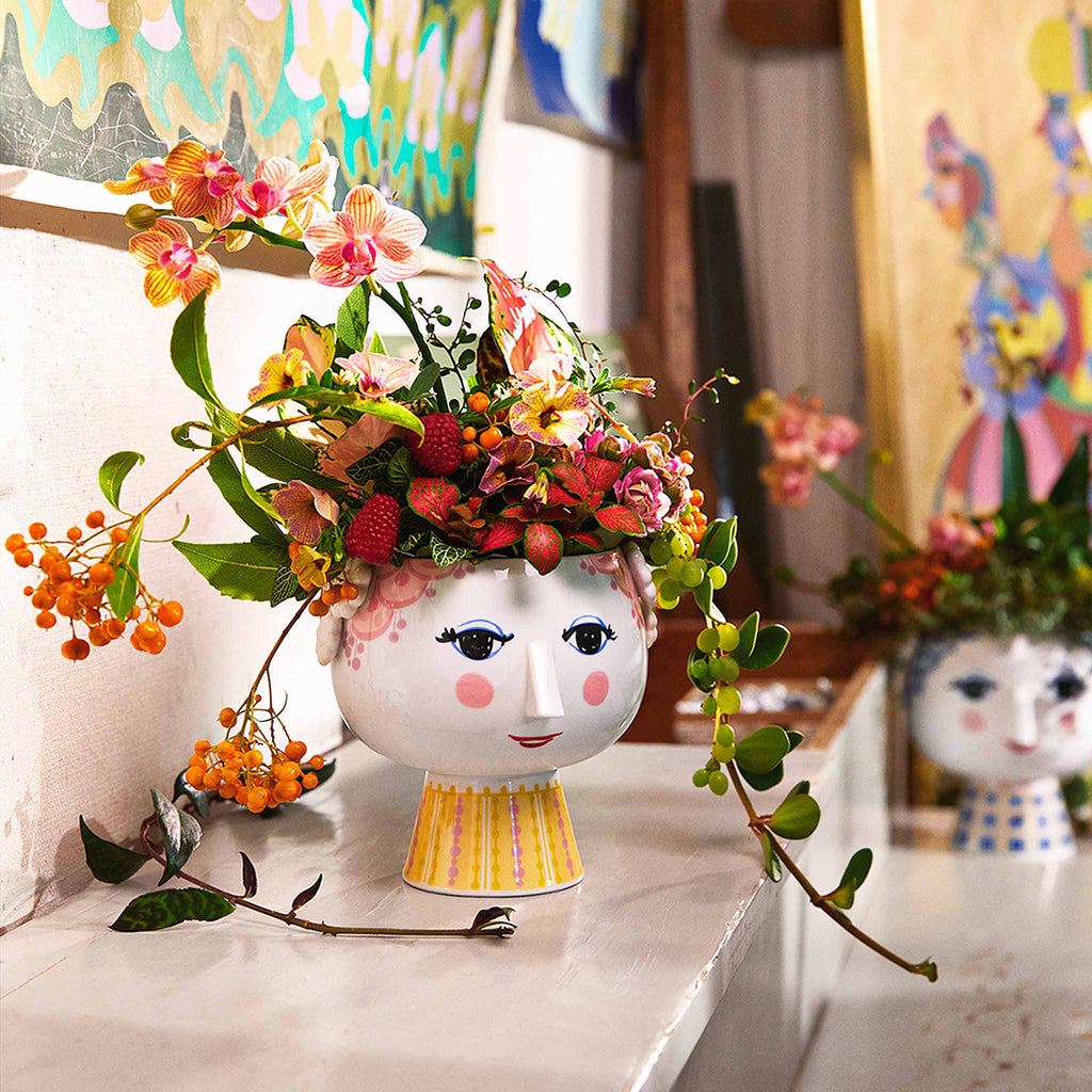 Bjørn Wiinblad represents everything that is crazy, quirky, creative and wonderful. And with the beautiful and smiling Eva flowerpot from Bjørn Wiinblad with pink hair and a bright pink and yellow dress, you can create a quirky, colourful vibe throughout your home. 