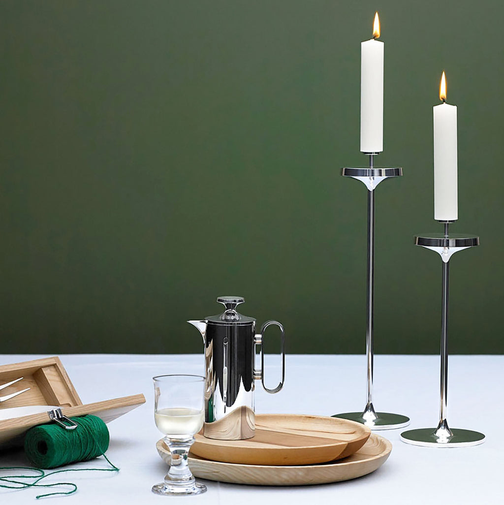 David Mellor Embassy stainless steel candlesticks. Originally designed in 1963 for use in British embassies abroad and previously only available in silver plate, we are pleased to now introduce a stainless steel version of this design classic. These spectacular candlesticks add real height and elegance to a table setting. Use individually or group together different heights.