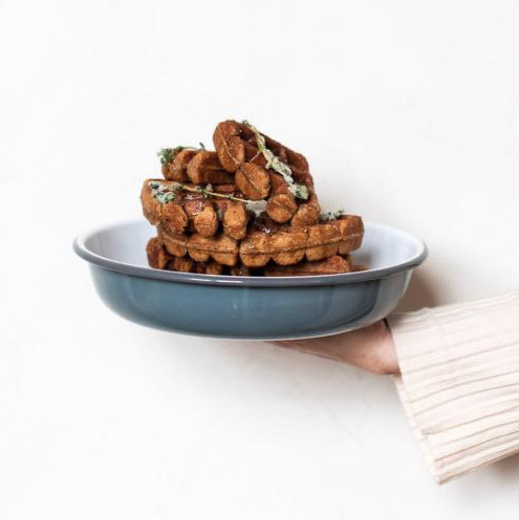 Our larger serving dish is a statement piece for serving a feast. Oven safe, it can also be used for baked oatmeal or your favourite pie. Enamelware is made from powdered glass which is bonded onto heavy-gauge steel. Firstly, the product's form is pressed from a sheet of steel, and then dipped in liquid enamel before being fired in a kiln.