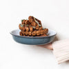 Our larger serving dish is a statement piece for serving a feast. Oven safe, it can also be used for baked oatmeal or your favourite pie. Enamelware is made from powdered glass which is bonded onto heavy-gauge steel. Firstly, the product's form is pressed from a sheet of steel, and then dipped in liquid enamel before being fired in a kiln.