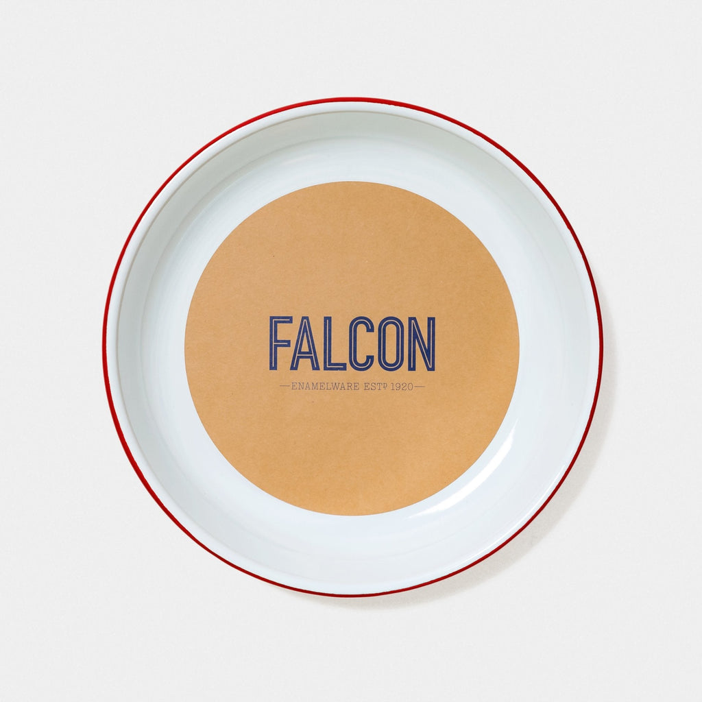 Falcon Enamelware Medium Serving Dish in Pillarbox Red. The tonal colour of our products may vary slightly from what is shown on our website or with our other products. This is due to our manufacturing methods. Each item is hand dipped in a thick enamel glaze and then fired in the kiln in extremely high temperatures. Depending on the product, this process can be repeated numerous times. The coloured pigment in the glaze reacts during the firing process, giving each piece its own varying character.  