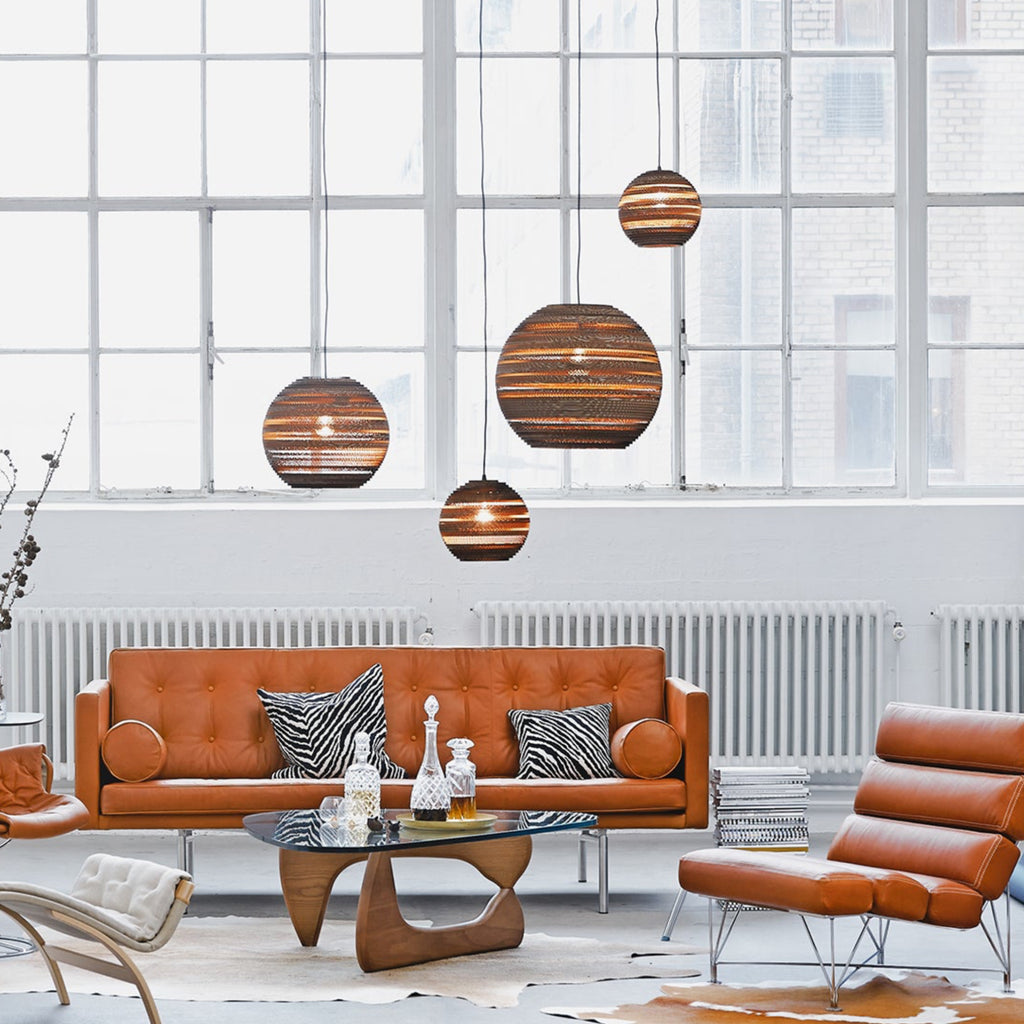 Handcrafted from recycled or pure white cardboard, Graypants’ flagship Scraplights series provides warm, intimate, and functional lighting for any occasion or type of space. Tough and elegant, each shade is precision cut with a laser (natural & blonde shades) or precision cut on advanced machinery (white shades) and assembled by hand using a nontoxic adhesive. All Scraplights are treated with an environmentally friendly fire retardant and are inscribed with the name of their artisan maker!