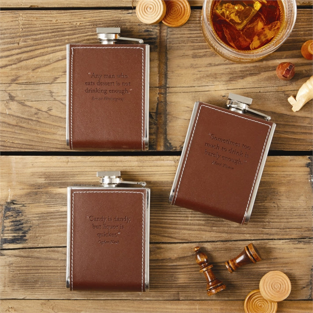 Crafted with a distinct flair for the sophisticated, the 'Words To Live By' flask from Two's Company is a unique addition to any collection. The smooth leather construction promises durability and a touch of elegance, while the engraved message, "Candy is Dandy but Liquor is Quicker," adds a playful twist to this classic piece. Ideal for toasting special occasions or simply as a conversational piece, this flask is a versatile accessory for any enthusiast. Whether it's a thoughtful gift or a treat for yourse