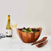 Elegant lines and flowing curves done in rich, gorgeous acacia wood make the Harmony Salad Set an instant classic. The generously rounded bowl paired with the unique shape of the tongs make it easy to toss and arrange your healthy creations. SKU: MT0582.