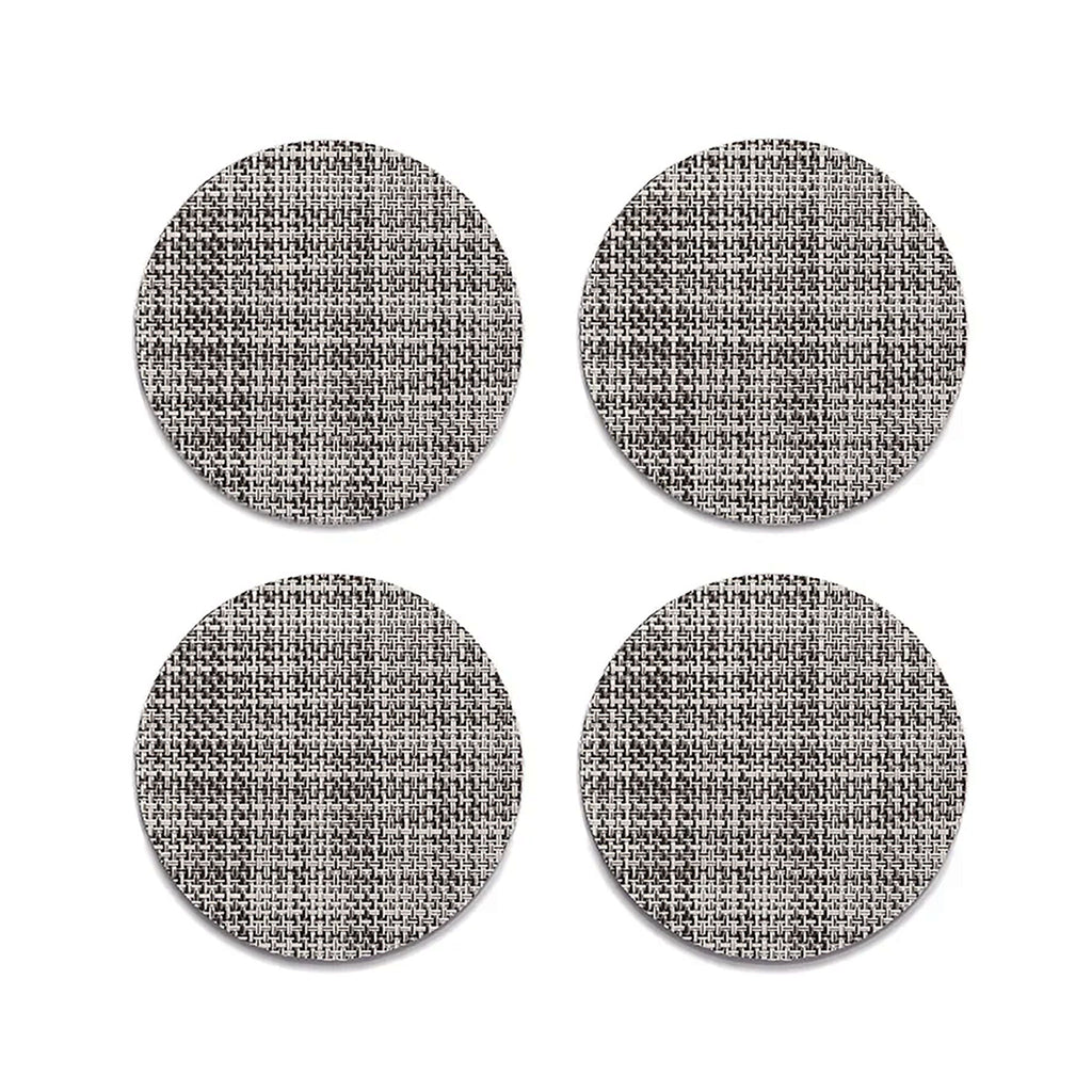 Chilewich Mini Basketweave Gravel Coasters (Set of 4). SKU 100743-010. A plush, protective layer of our BioFelt® backing cushions these durable yet refined coasters. Elegantly banded in sets of four, they are ready for gifting. Made from recycled fibers, the cushioned base layer protects the underlying surface from moisture. Each coaster set includes four coasters in a single color. Suitable for indoor and outdoor use. Made in the USA. Free of phthalates.