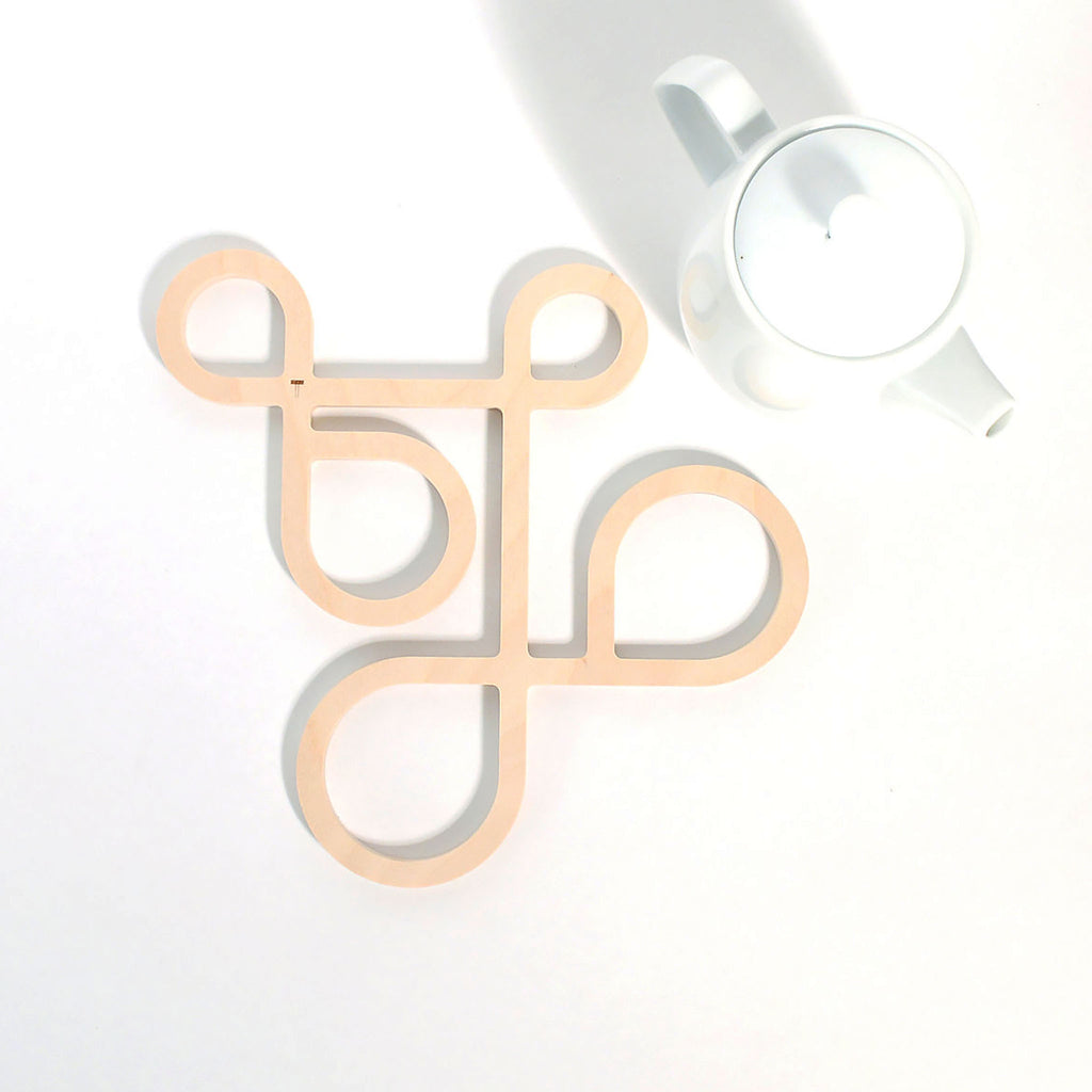 Decorate your table and protect the tablecloth with Inside Out wood trivets by Anne Thomas of TOMA Objects. Made of natural finish birch plywood. (A trivet is an object between a hot pan or serving dish and the table or countertop.) They have great heat resistance and prevent damage to surfaces caused by high heat. 